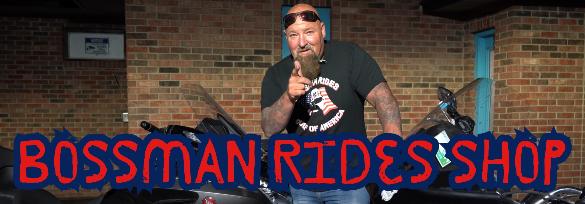 bossman rides shop image with jeremy standing next to his bikes with his gulf of america bossman rides t-shirt on